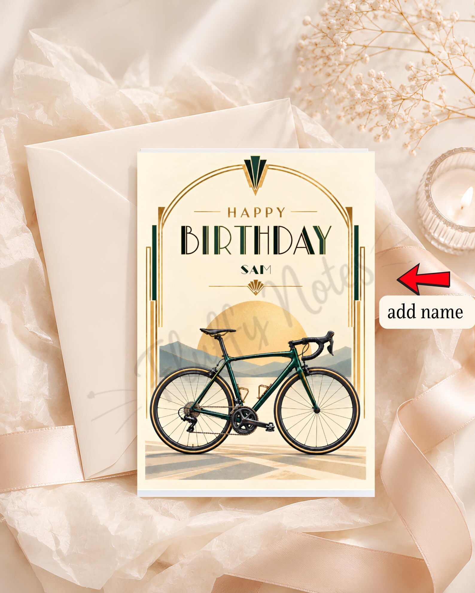 Personalized bicycle birthday card with a green road bike, mountains, golden sun and Art Deco border, showing the example name Sam and the original watermark